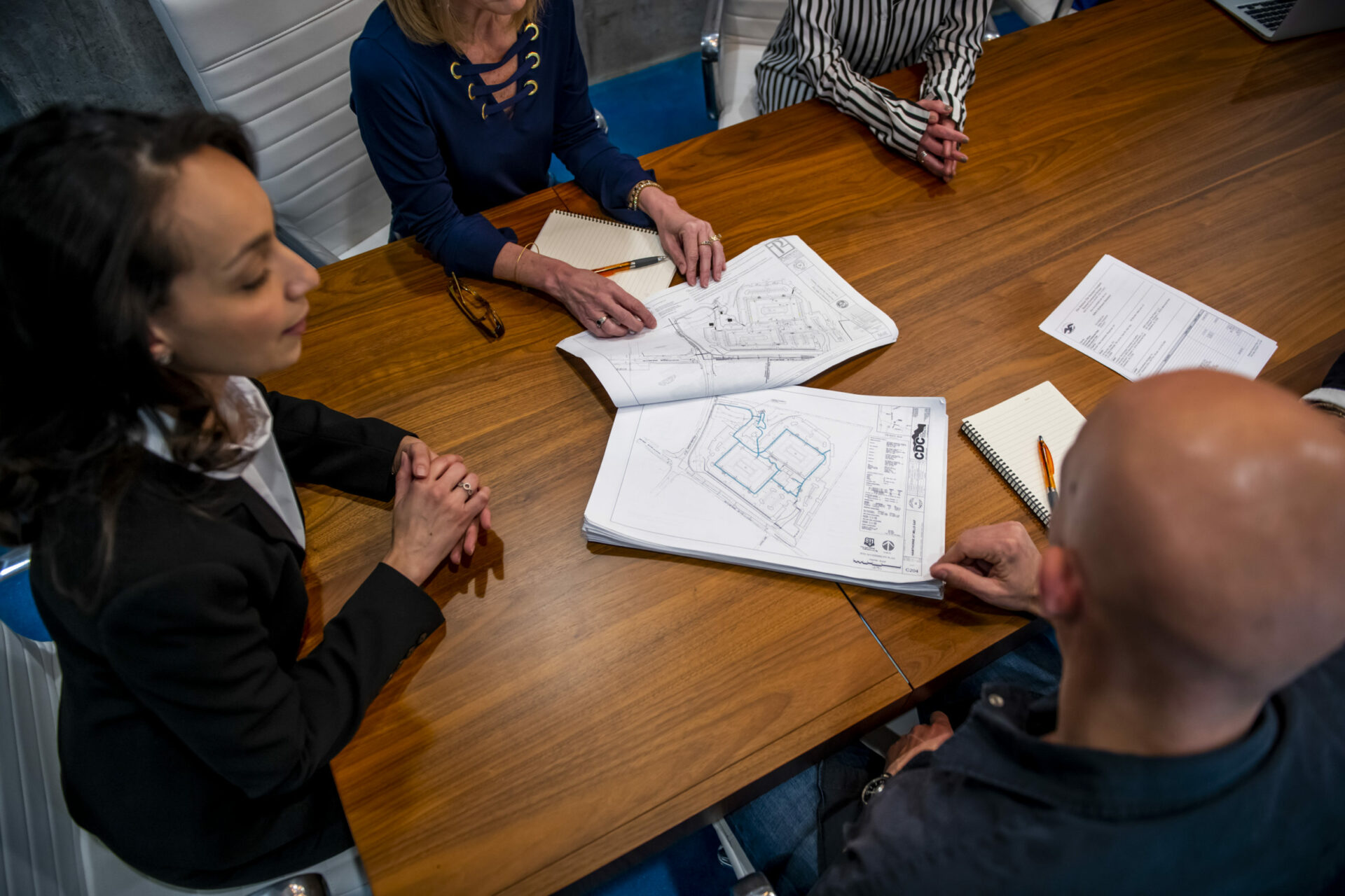 conference table with construction blueprints