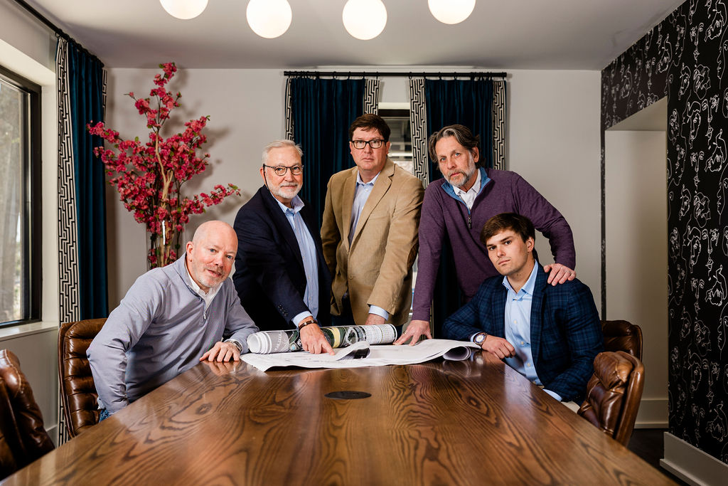 Michael Spafford and other Evolve employees looking at plans in conference room