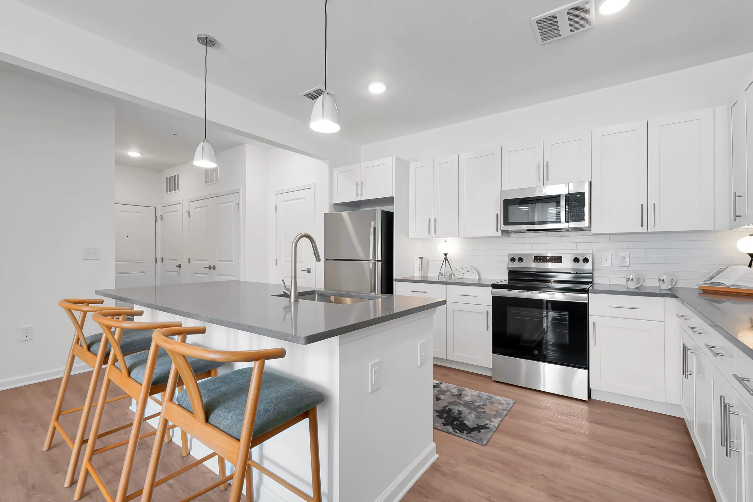 white kitchen with island at evolve at palm coast