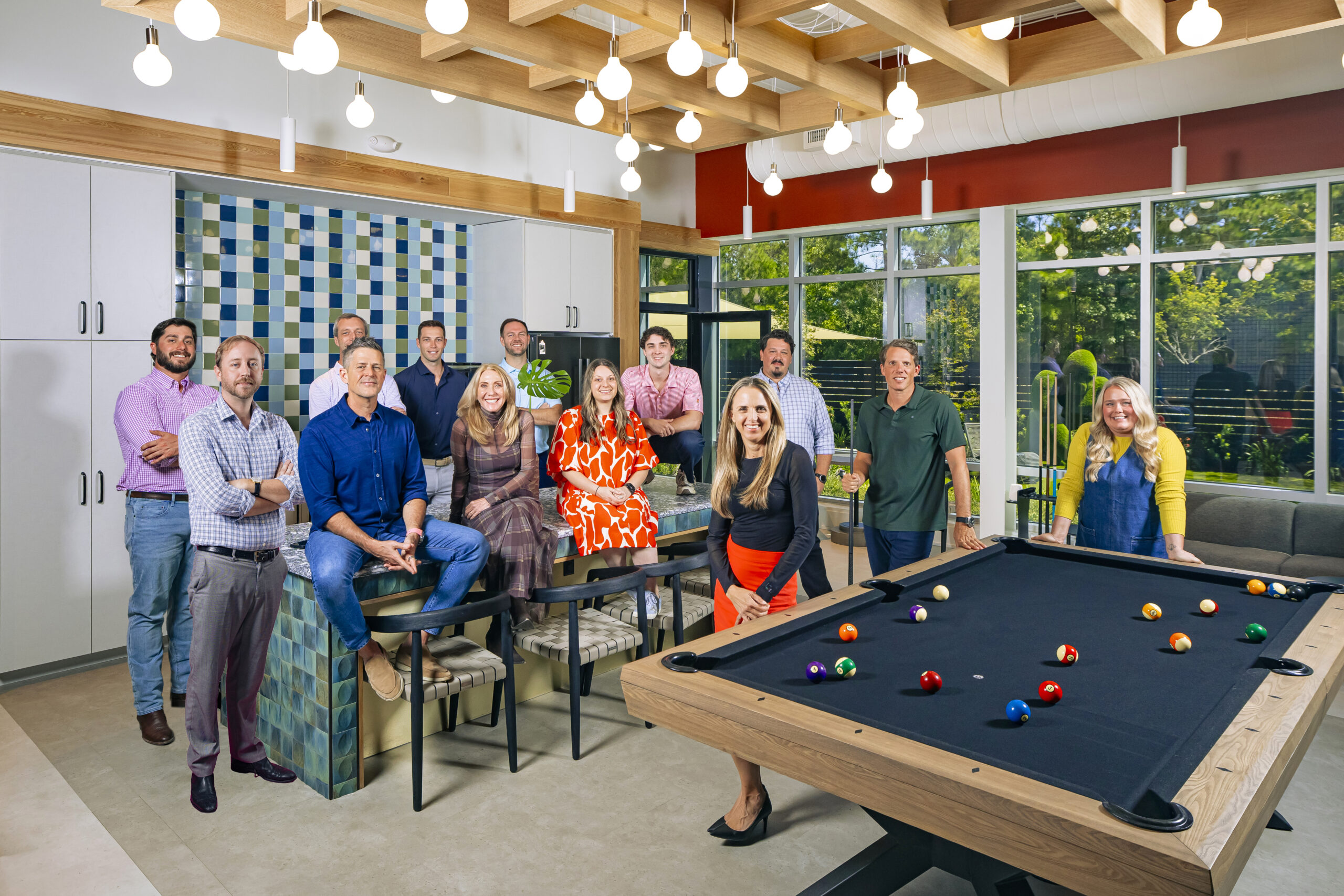 Evolve Companies team at Wilmington headquarters poses in game room.
